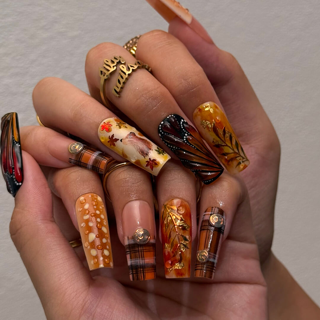 Luxury press-on nails with plaid patterns, golden foil leaves, tortoiseshell swirls, and warm caramel tones — handmade long almond nails — perfect for fall-inspired nail art, luxury everyday style, or elegant seasonal looks.