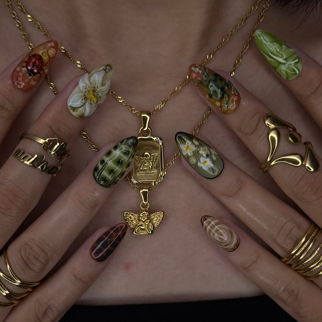 3D enchanted forest press-on nails with sculpted mushrooms, frogs, ladybugs, flowers, and woodland textures in earthy greens, browns, and reds — handmade medium almond nails — perfect for fairytale nail art, mystical styles, or fall luxury looks.