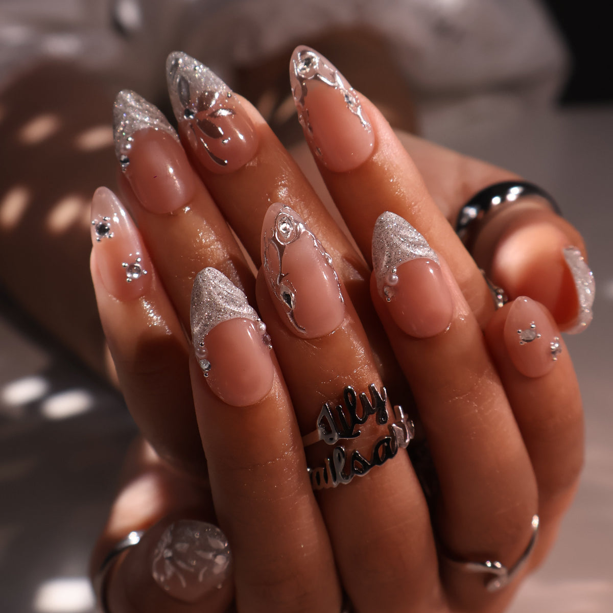 3D silver chrome press on nails with glitter V-tips and sculpted leaf accents, embellished with crystals and silver beads on a nude base — custom press on nails, luxury handmade nail art, fake nails, false nails, pressons — perfect for prom, winter formal, and silver-themed events