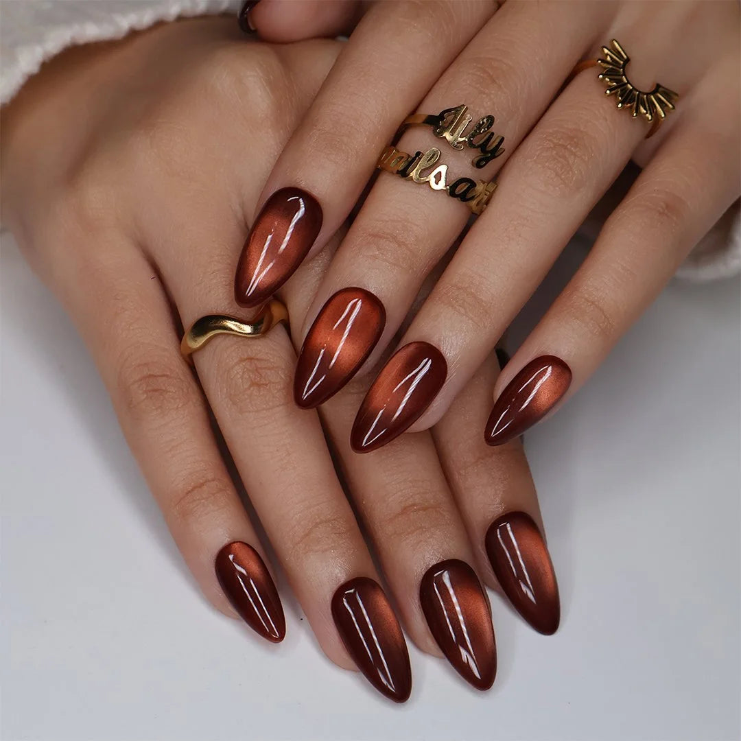 Brown Sugar handmade fall press-on nails — Medium almond set in rich caramel-brown with golden cat-eye shimmer, glossy molten finish and minimalist autumn nail art.