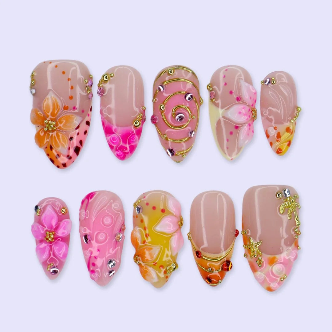 Handmade summer press-on nails with coral pink blooms, 3D floral centerpiece, leopard dots and gold spiral details by Lily Nails Art