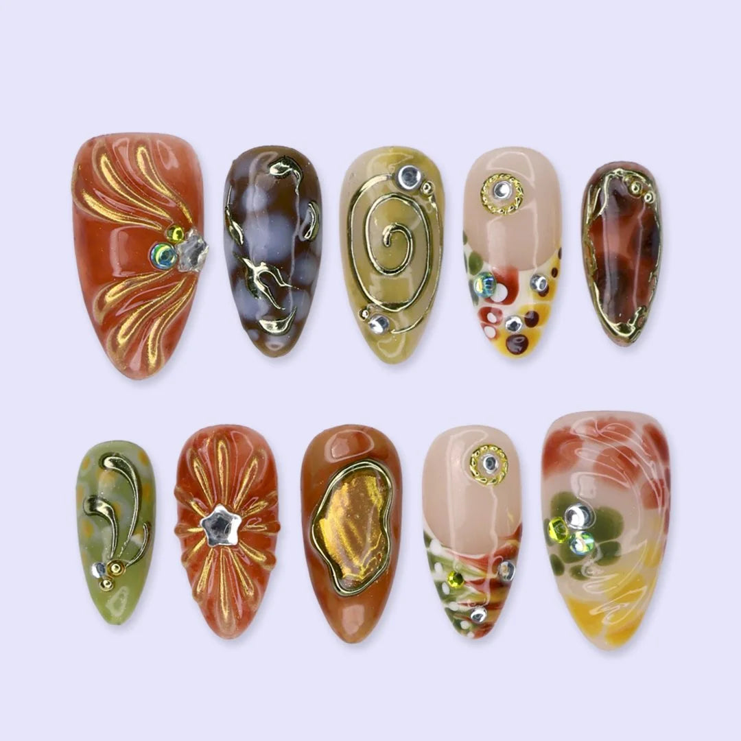Caramela handmade Y2K press-on nails — almond set in terracotta, olive and caramel with gold swirls and gems
