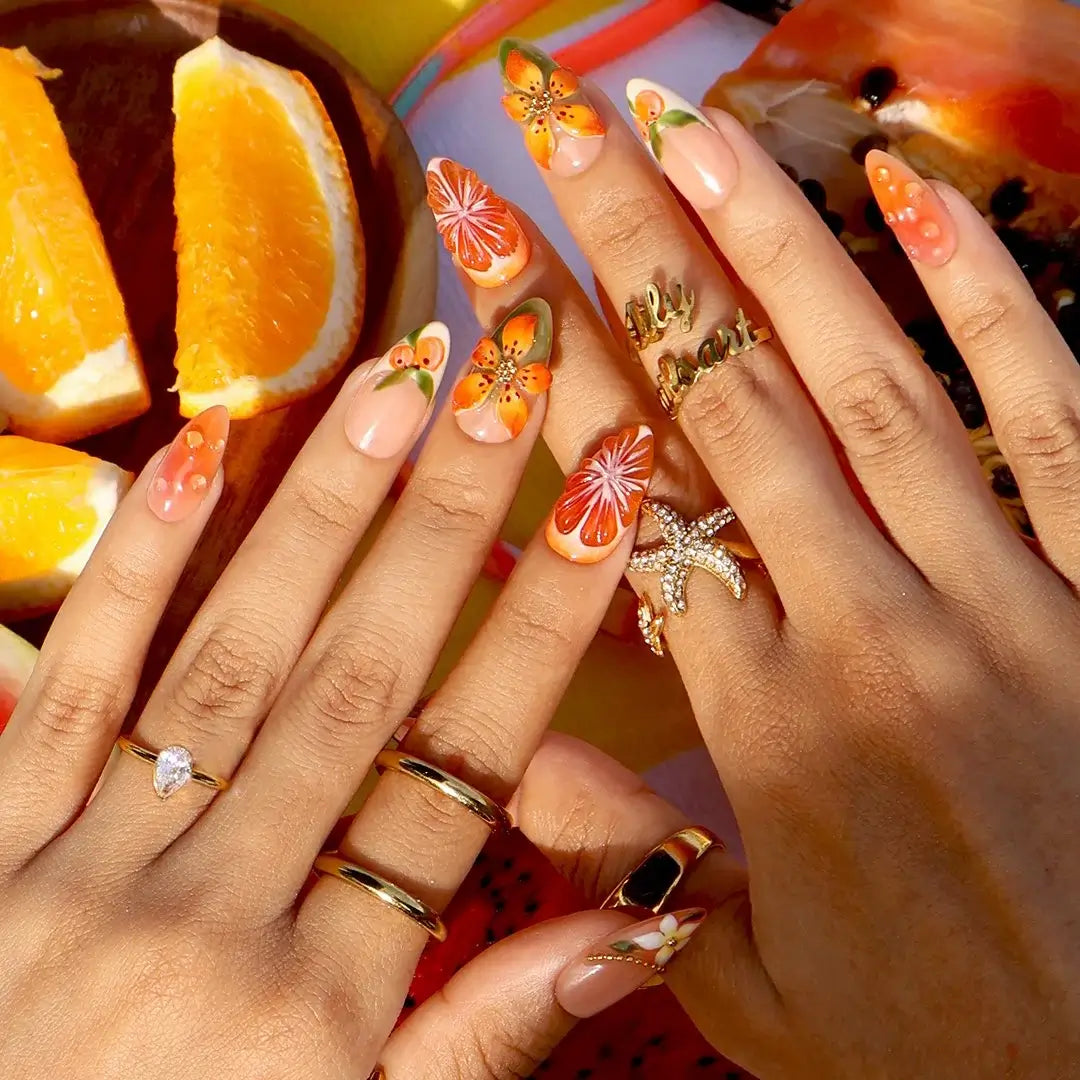 Handmade summer press-on nails with vivid citrus blooms, tropical floral art and gold bead embellishments by Lily Nails Art