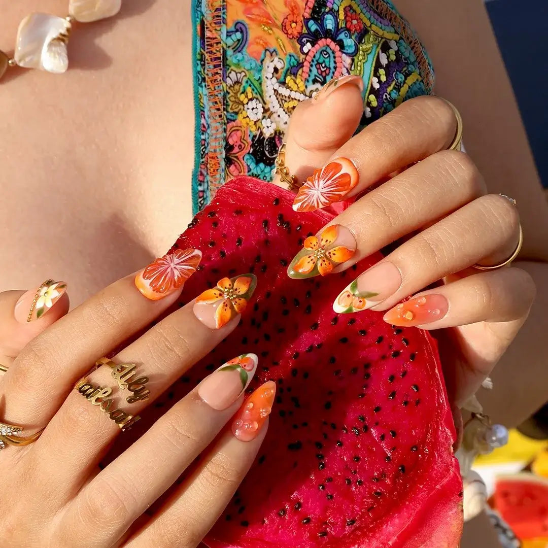 Handmade summer press-on nails with vivid citrus blooms, tropical floral art and gold bead embellishments by Lily Nails Art