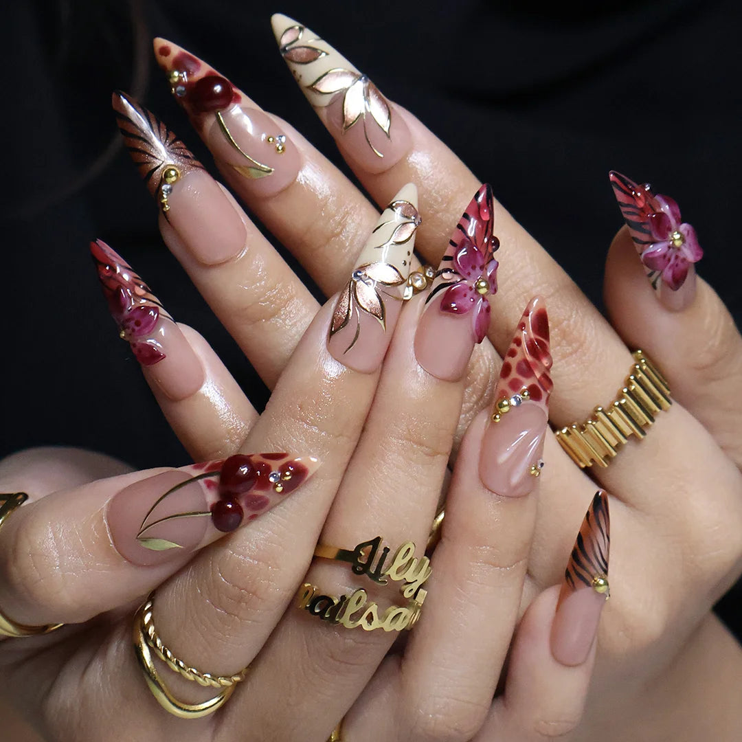 Marsala handmade fall press-on nails — long almond set in nude and plum-magenta with 3D lilies, gold cat-eye petals and berry details