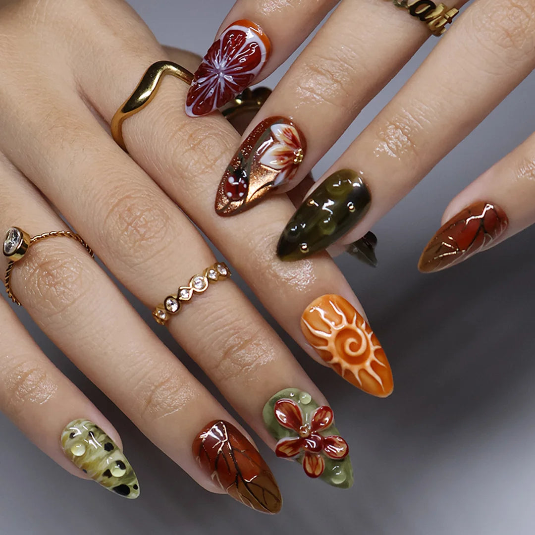 Wildwood handmade fall press-on nails — almond set in olive green, rust and terracotta with 3D dragonfly, ladybugs, orchids and gold leaf-vein linework