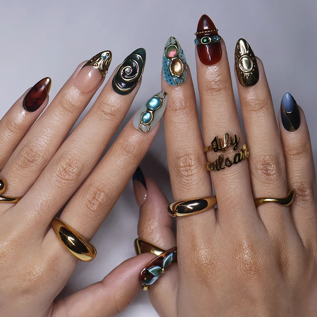 Solstice handmade maximalist press-on nails — almond set in teal, sage, rust and navy with a sculpted gold sun, 3D flower and jewel cabochons