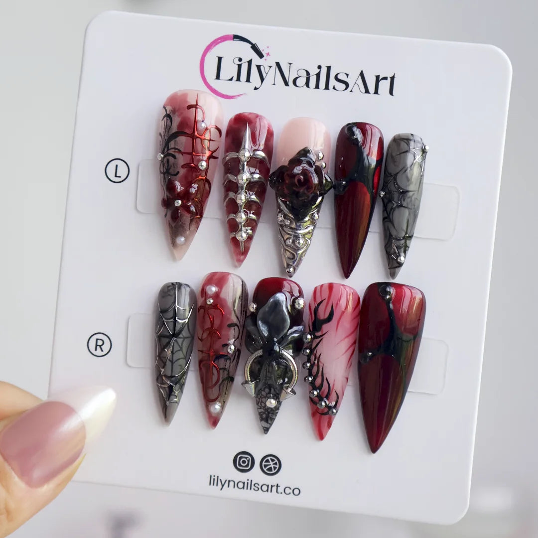 Velvet Bite gothic press on nails in blood red, black and smoky grey with a 3D spider, spiderwebs, black rose, silver studs and thorny vines — handmade Halloween press on nails, long stiletto fake nails and vampire gothic nail art.