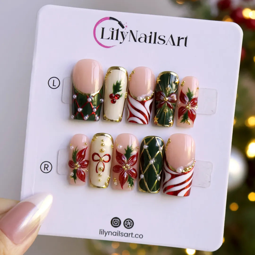 Yulamar handmade Christmas press-on nails — medium square set in nude, deep green and cream with 3D red poinsettias, red and gold bows, holly berries, candy-cane swirls, gold lattice details and pearl accents.