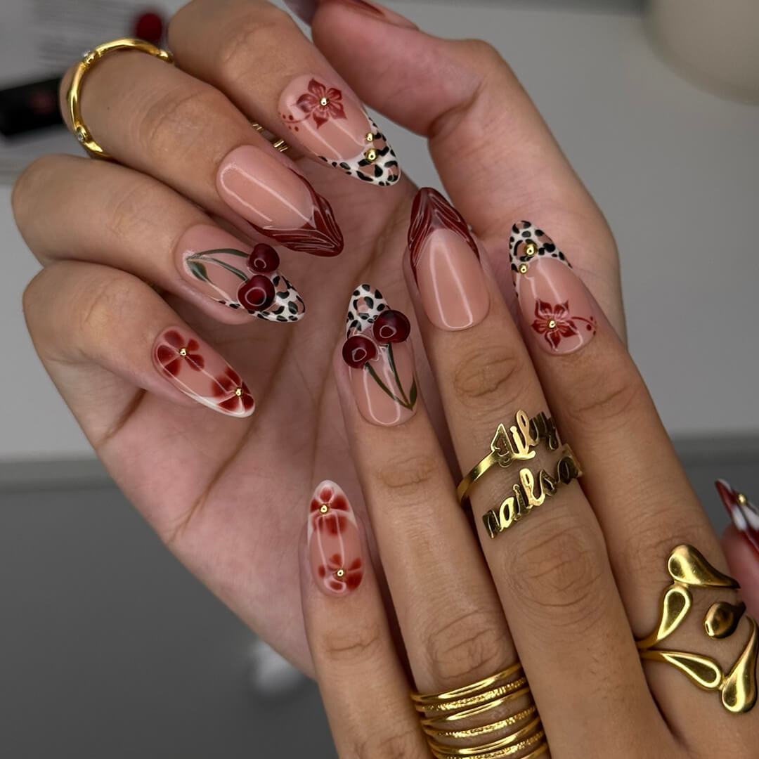 Cherry red press-on nails with hand-painted florals, subtle leopard accents, and glossy crimson tips — luxury handmade medium almond nails — perfect for elegant fall everyday looks, romantic evenings