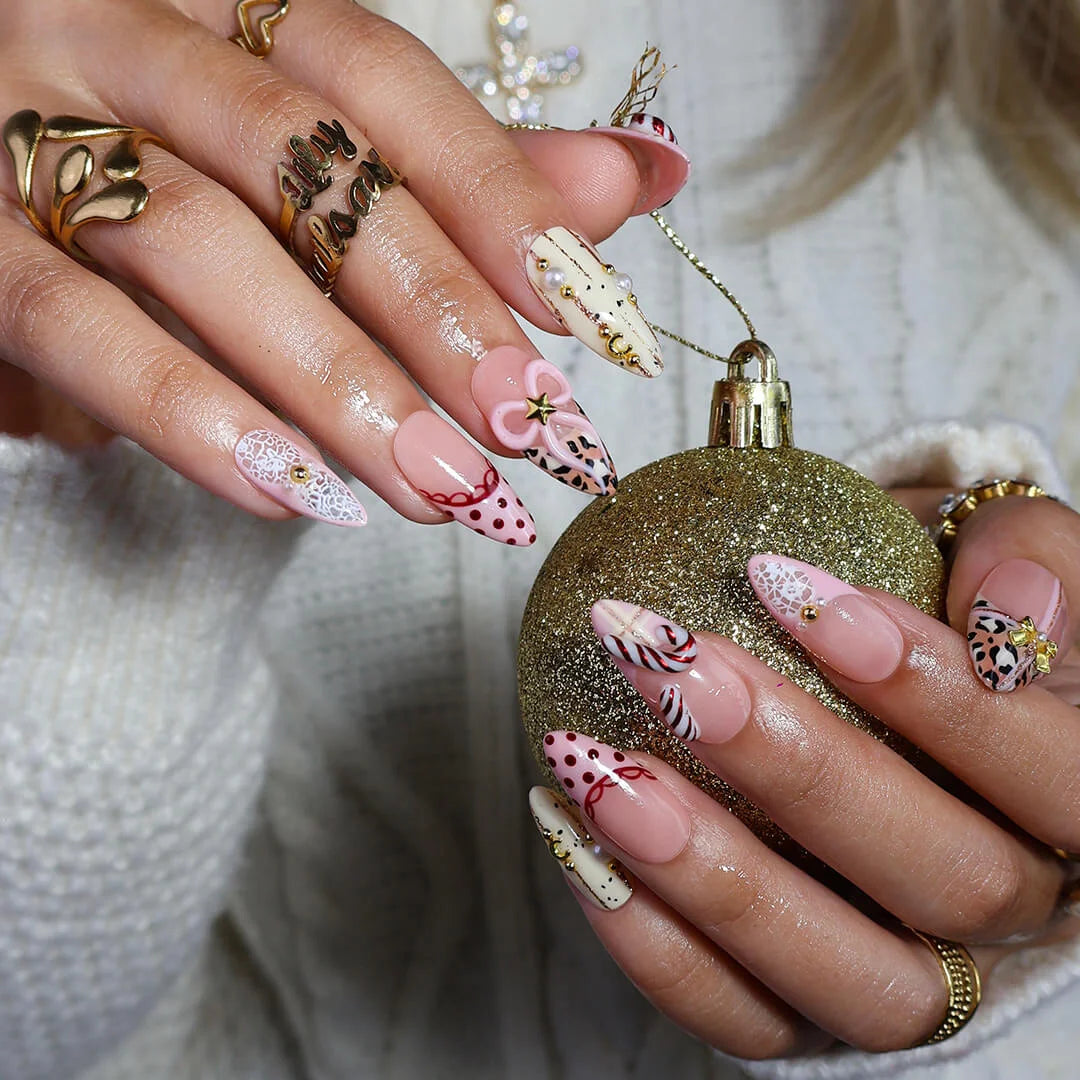 3D pink leopard print press on nails with red candy cane, gold bow, and peppermint swirl accents — handmade Christmas 2025 nails, festive fake nails, holiday nail art