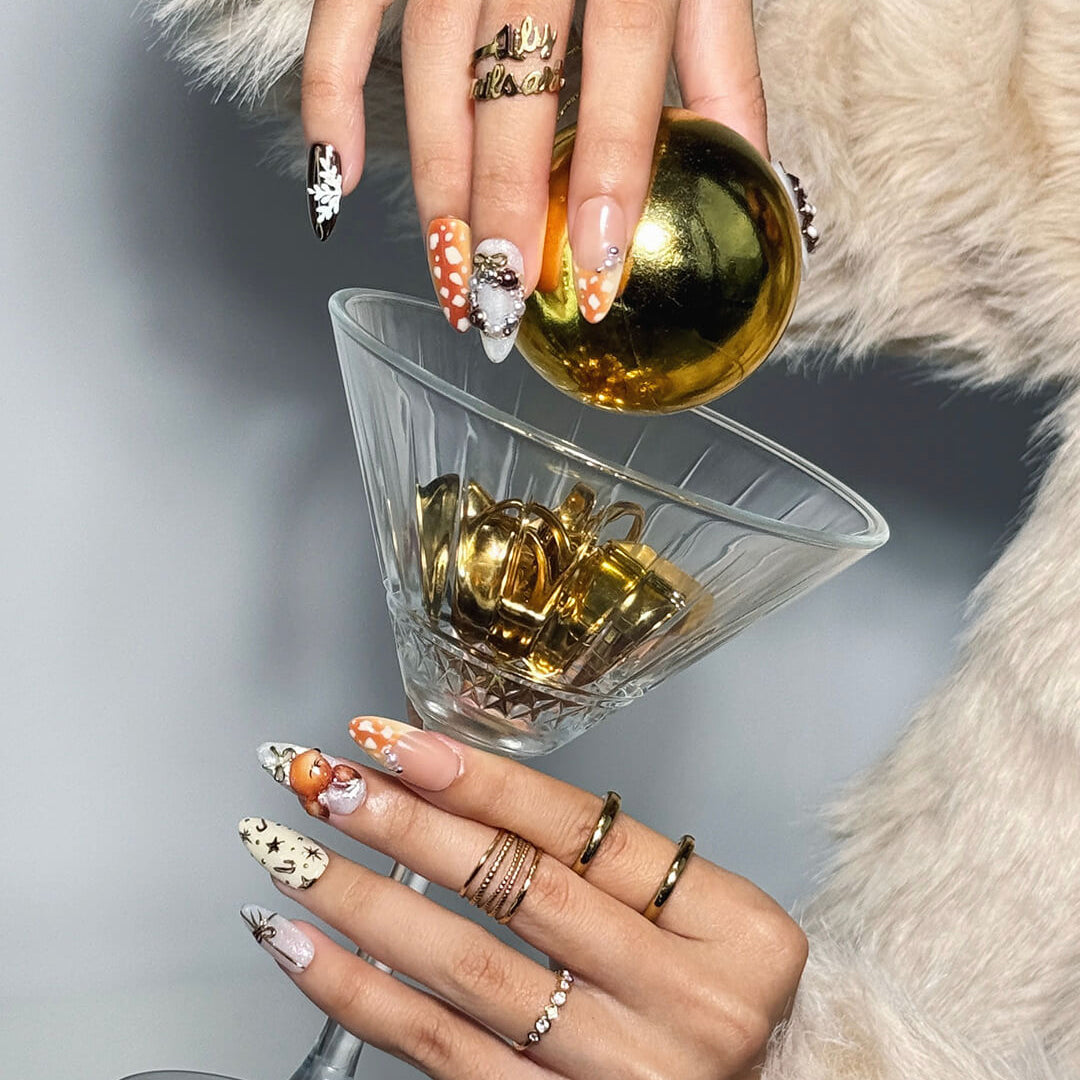 3D holiday press on nails in nude, caramel, and white with reindeer art, candy cane swirls, Christmas tree charms, metallic gold details — luxury handmade Christmas nails, reusable false nails, festive nail art — perfect for winter parties, holiday gifts, or cozy glam nights.