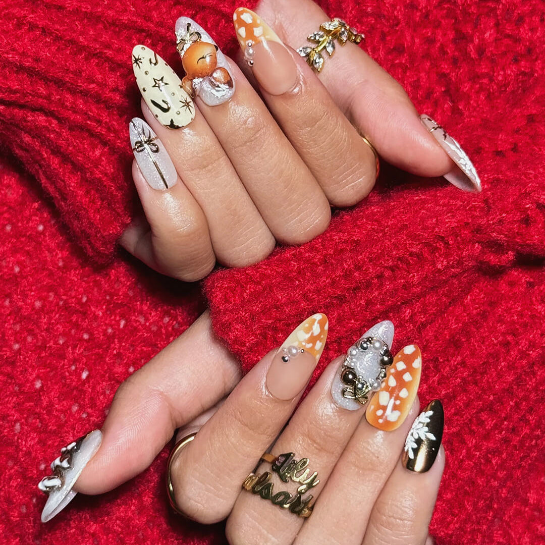 3D holiday press on nails in nude, caramel, and white with reindeer art, candy cane swirls, Christmas tree charms, metallic gold details — luxury handmade Christmas nails, reusable false nails, festive nail art — perfect for winter parties, holiday gifts, or cozy glam nights.