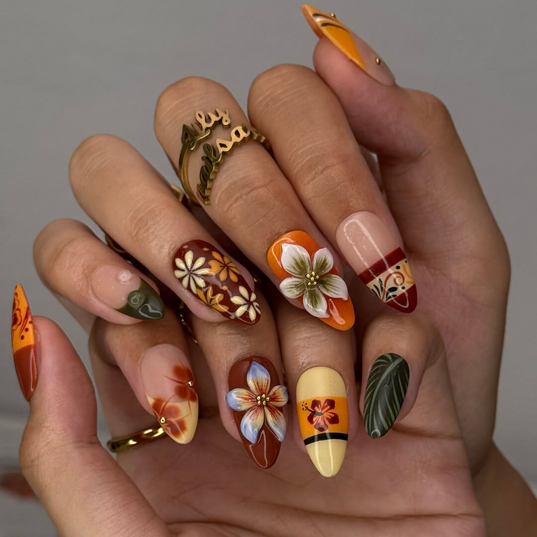 Fall inspired press-on nails with hibiscus flowers, tropical leaf accents, and gradients of red, orange, and golden tones — luxury handmade medium almond nails inspired by Tahitian sunsets and glowing embers — perfect for fall look, holiday