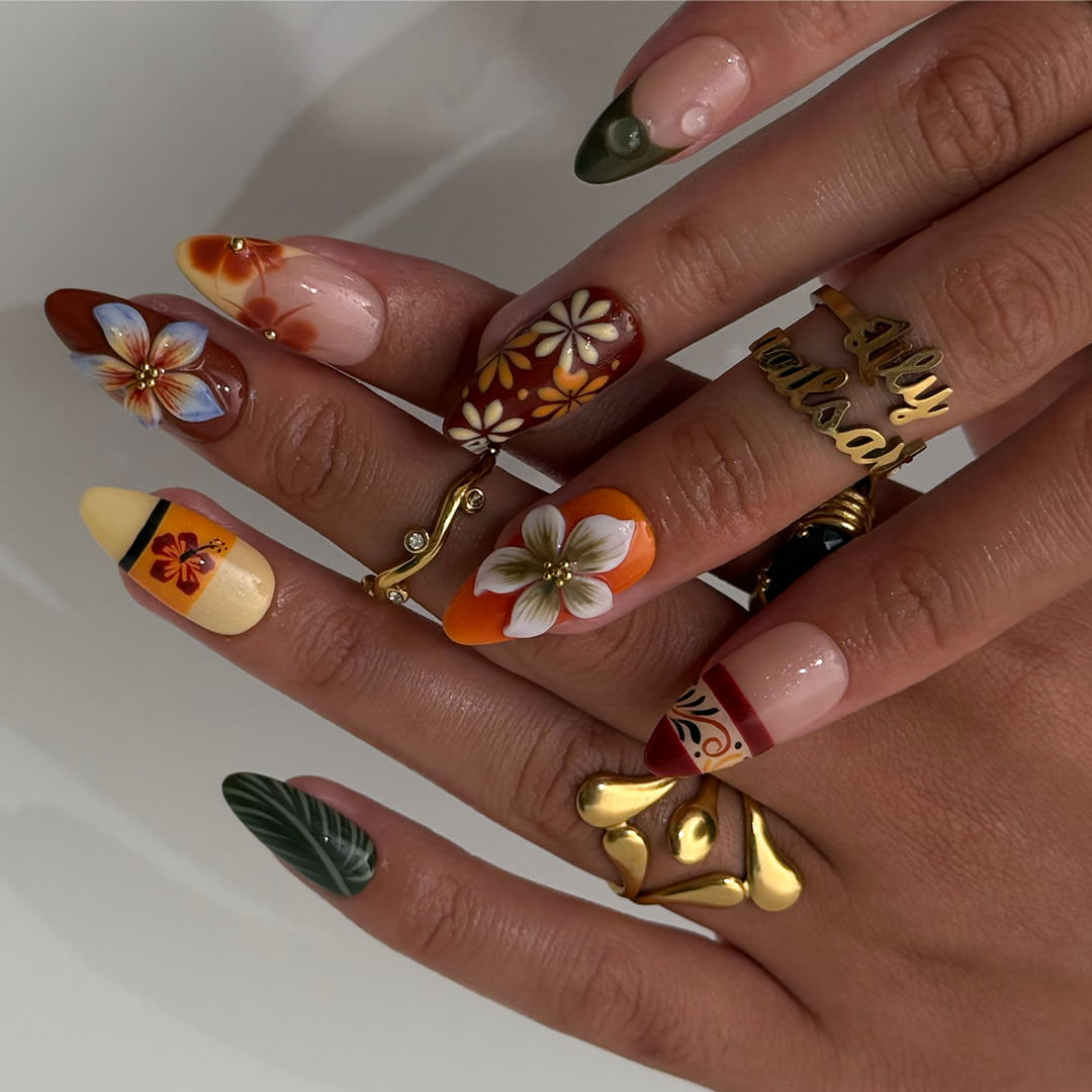Fall inspired press-on nails with hibiscus flowers, tropical leaf accents, and gradients of red, orange, and golden tones — luxury handmade medium almond nails inspired by Tahitian sunsets and glowing embers — perfect for fall look, holiday