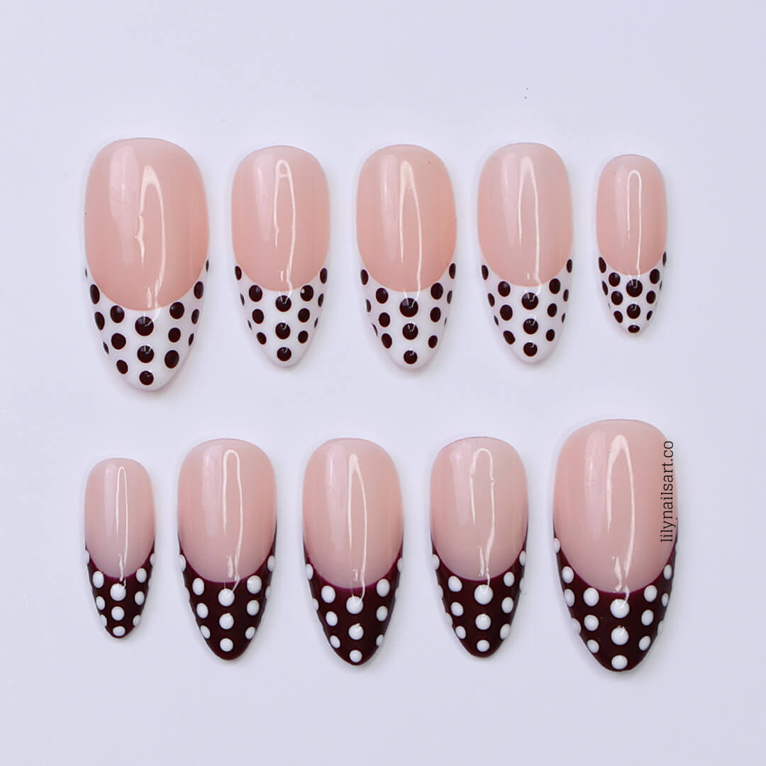 Brown and white polka dot press-on nails with French tip design, medium almond shape — handmade custom fake nails, perfect for holiday style or everyday wear