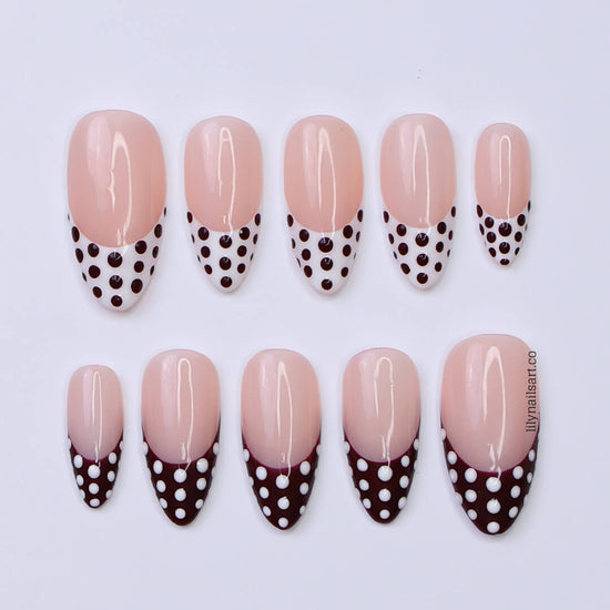 Brown and white polka dot press-on nails with French tip design, medium almond shape — handmade custom fake nails, perfect for holiday style or everyday wear