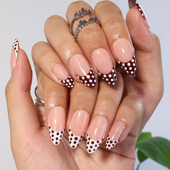 Brown and white polka dot press-on nails with French tip design, medium almond shape — handmade custom fake nails, perfect for holiday style or everyday wear