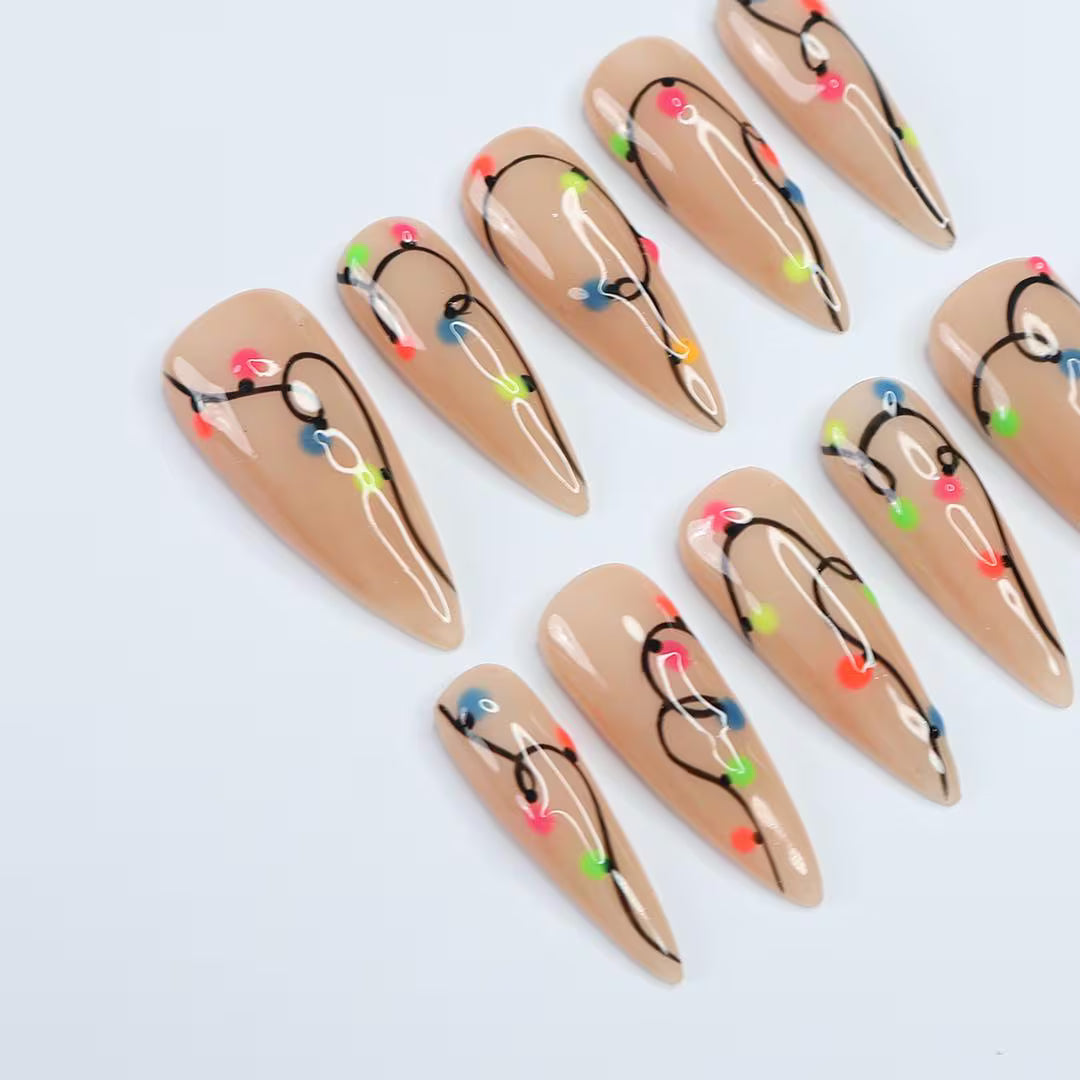 Handmade Christmas press on nails with colorful glowing light string design on stiletto shape — custom holiday nails, luxury fake nails, festive party nail art for Christmas looks and winter events.