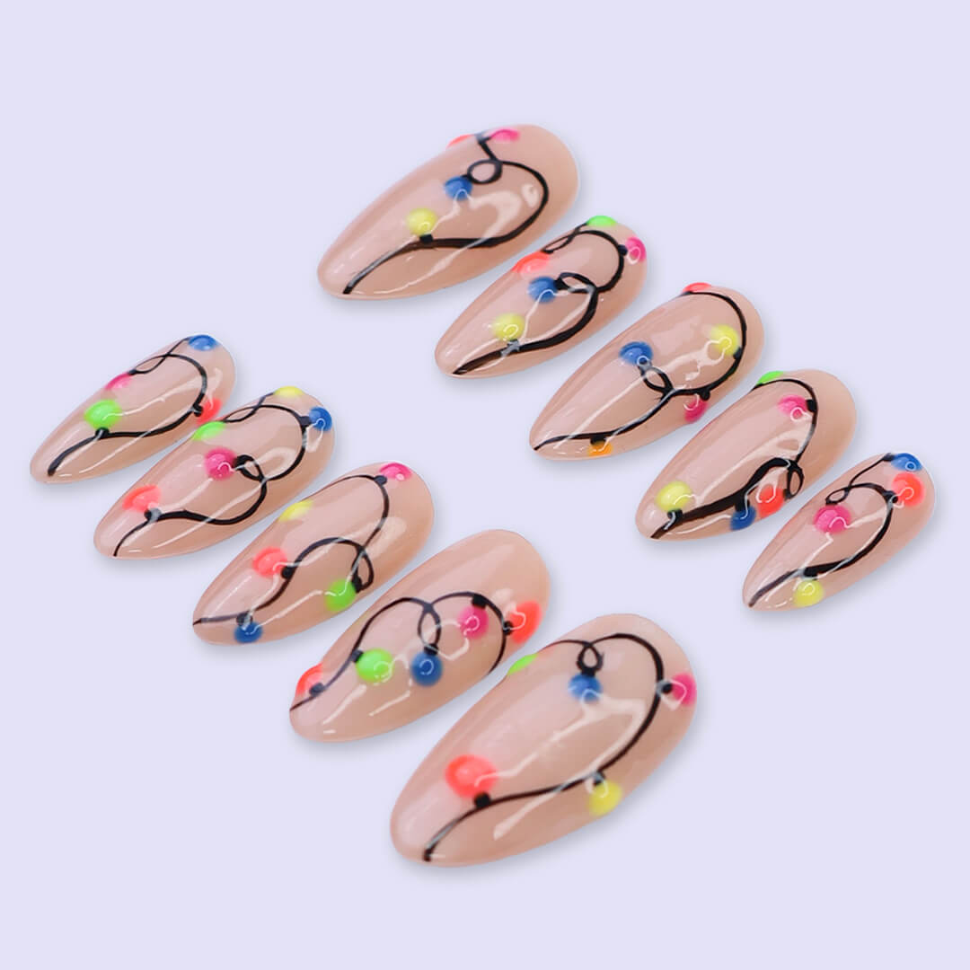 Handmade Christmas press on nails with colorful glowing light string design on stiletto shape — custom holiday nails, luxury fake nails, festive party nail art for Christmas looks and winter events.