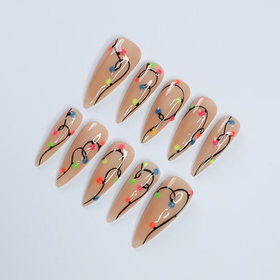 Handmade Christmas press on nails with colorful glowing light string design on stiletto shape — custom holiday nails, luxury fake nails, festive party nail art for Christmas looks and winter events.