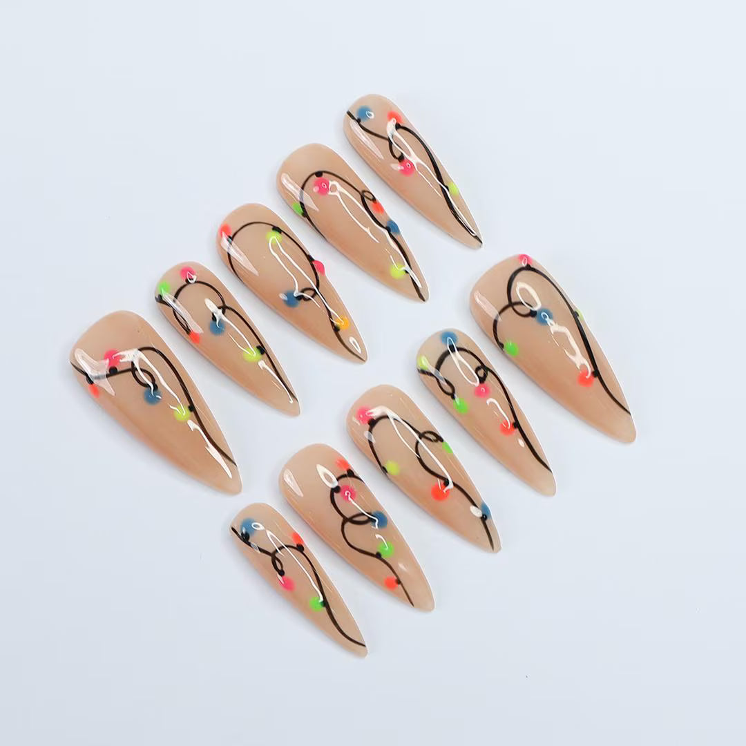 Handmade Christmas press on nails with colorful glowing light string design on stiletto shape — custom holiday nails, luxury fake nails, festive party nail art for Christmas looks and winter events.