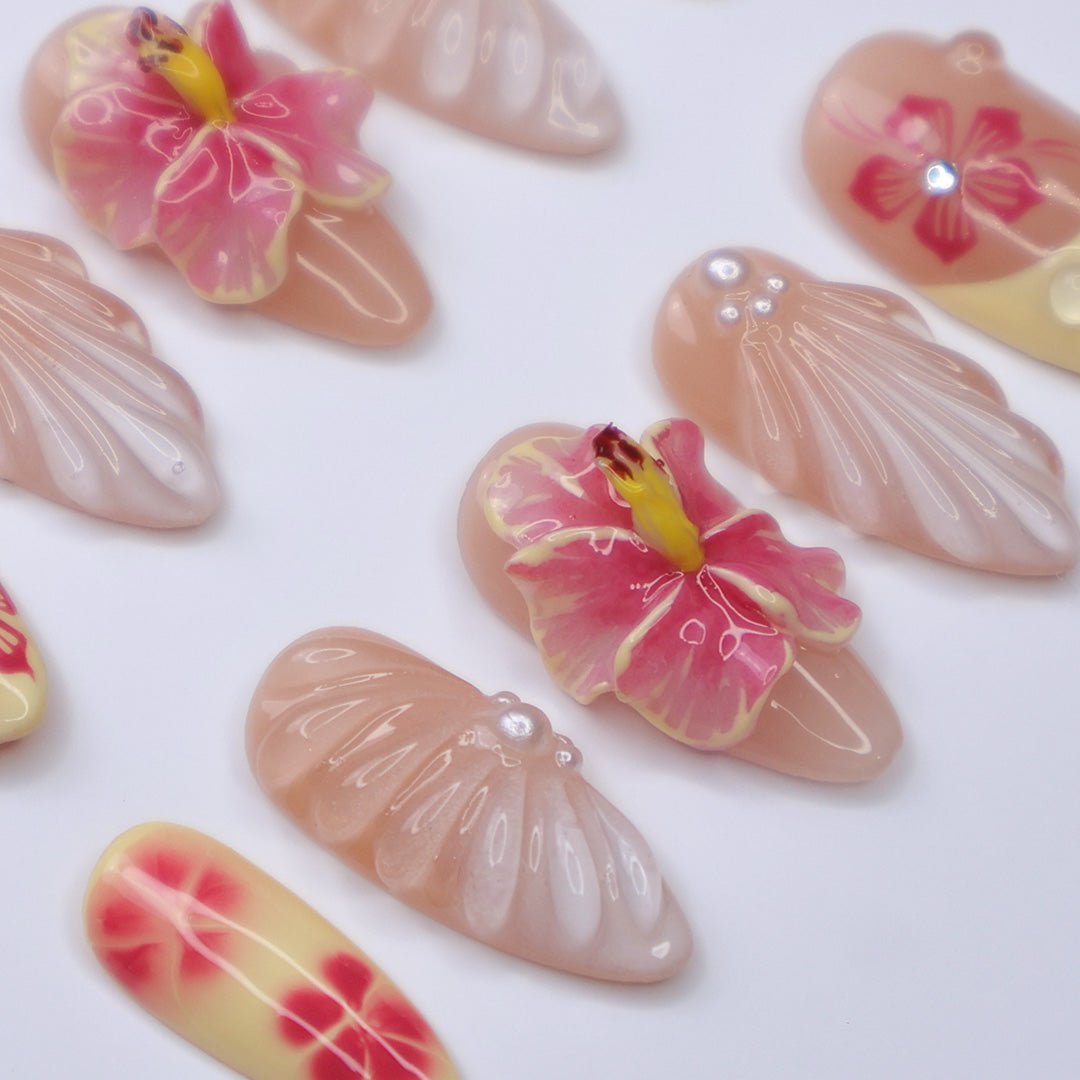 3D tropical summer press on nails with pink hibiscus flowers, seashell textures, and soft yellow tips, embellished with pearls and rhinestones — featuring sculpted petals, glossy finishes, and floral beach vibes — summer vacation nails, tropical flower press on nails, custom handmade nail art, fake nails, false nails, pressons — perfect for summer holidays, beach trips, or destination weddings.