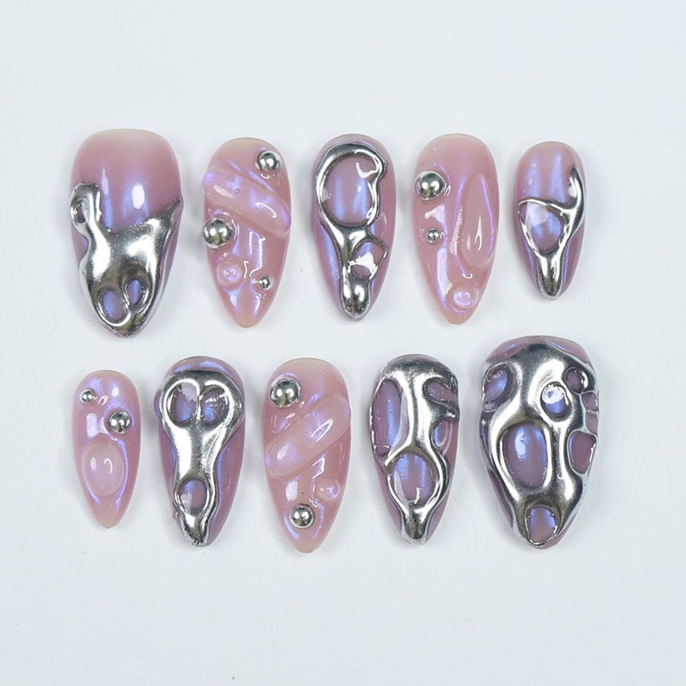 Futuristic designer press-on nails with a chrome liquid metal effect over an iridescent purple base. These edgy, 3D sculpted nails feature a high-shine mirror finish, creating a bold, modern look. A premium, reusable alternative to Kiss and Glamour Press-On Nails, perfect for trendsetters who love unique, high-fashion nail designs. Shop salon-quality press-on nails for a statement-making manicure that lasts