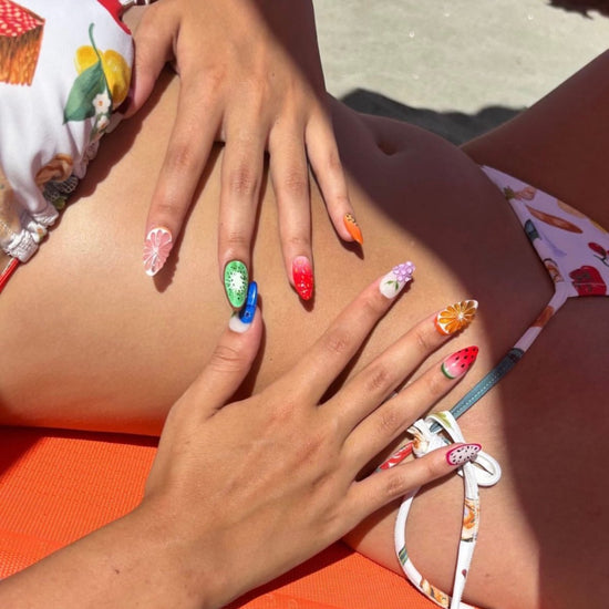 a model wearing 3D fruit press on nails with realistic designs of cherry, grapefruit, kiwi, strawberry, papaya, dragon fruit, watermelon, orange slice, grapes, and blueberries — custom press on nails, luxury handmade nail art, fake nails, false nails, pressons — perfect for summer vibes, fruity themes holiday, vacation ,or a fun gift for her.