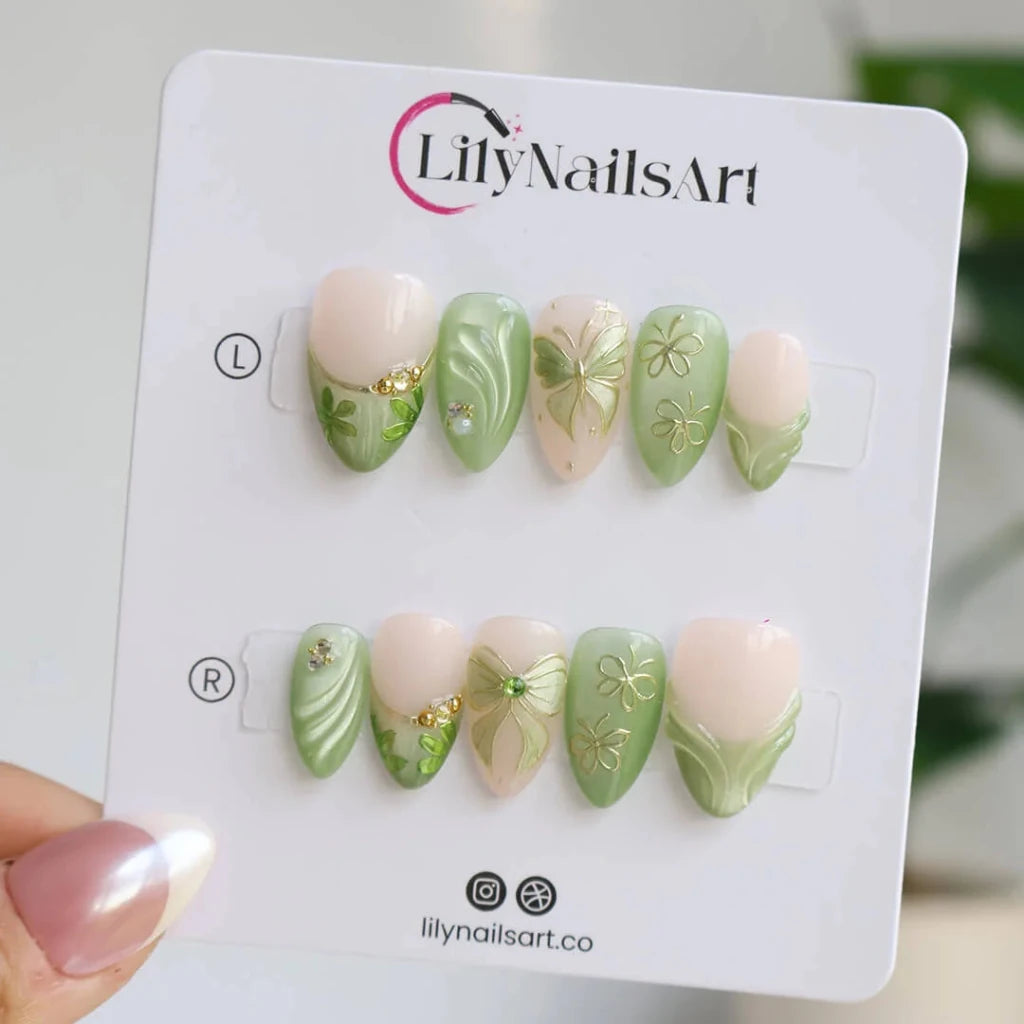 3D sage green chrome press on nails with gold bow and butterfly-lace accents, embellished with crystals and wave texture — custom press on nails, luxury handmade nail art, fake nails, false nails, pressons — perfect for prom, spring events, and garden parties