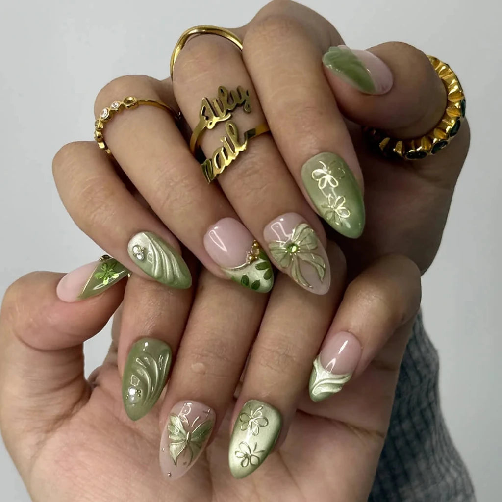 3D sage green chrome press on nails with gold bow and butterfly-lace accents, embellished with crystals and wave texture — custom press on nails, luxury handmade nail art, fake nails, false nails, pressons — perfect for prom, spring events, and garden parties
