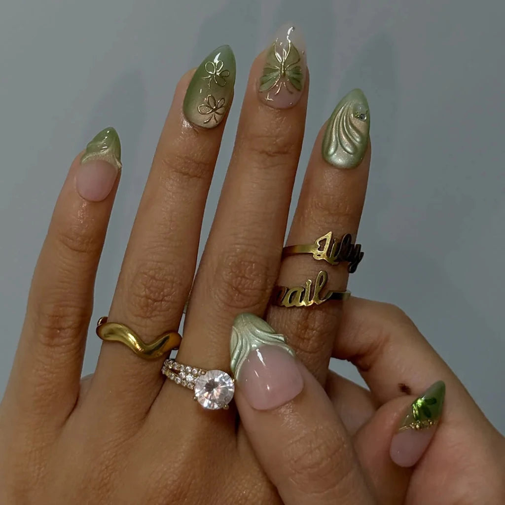 3D sage green chrome press on nails with gold bow and butterfly-lace accents, embellished with crystals and wave texture — custom press on nails, luxury handmade nail art, fake nails, false nails, pressons — perfect for prom, spring events, and garden parties