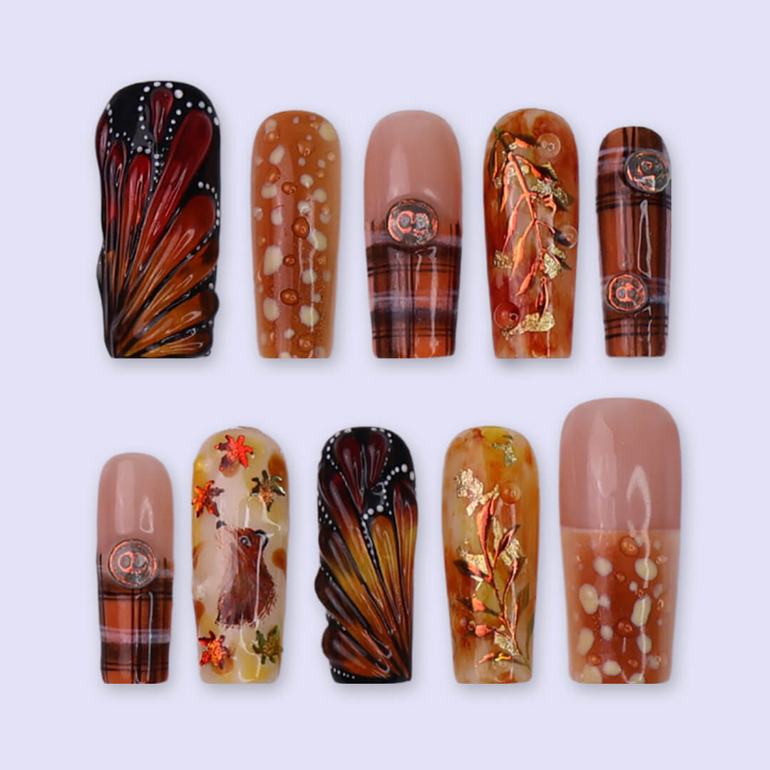 Luxury press-on nails with plaid patterns, golden foil leaves, tortoiseshell swirls, and warm caramel tones — handmade long square nails — perfect for fall-inspired nail art, luxury everyday style, or elegant seasonal looks.