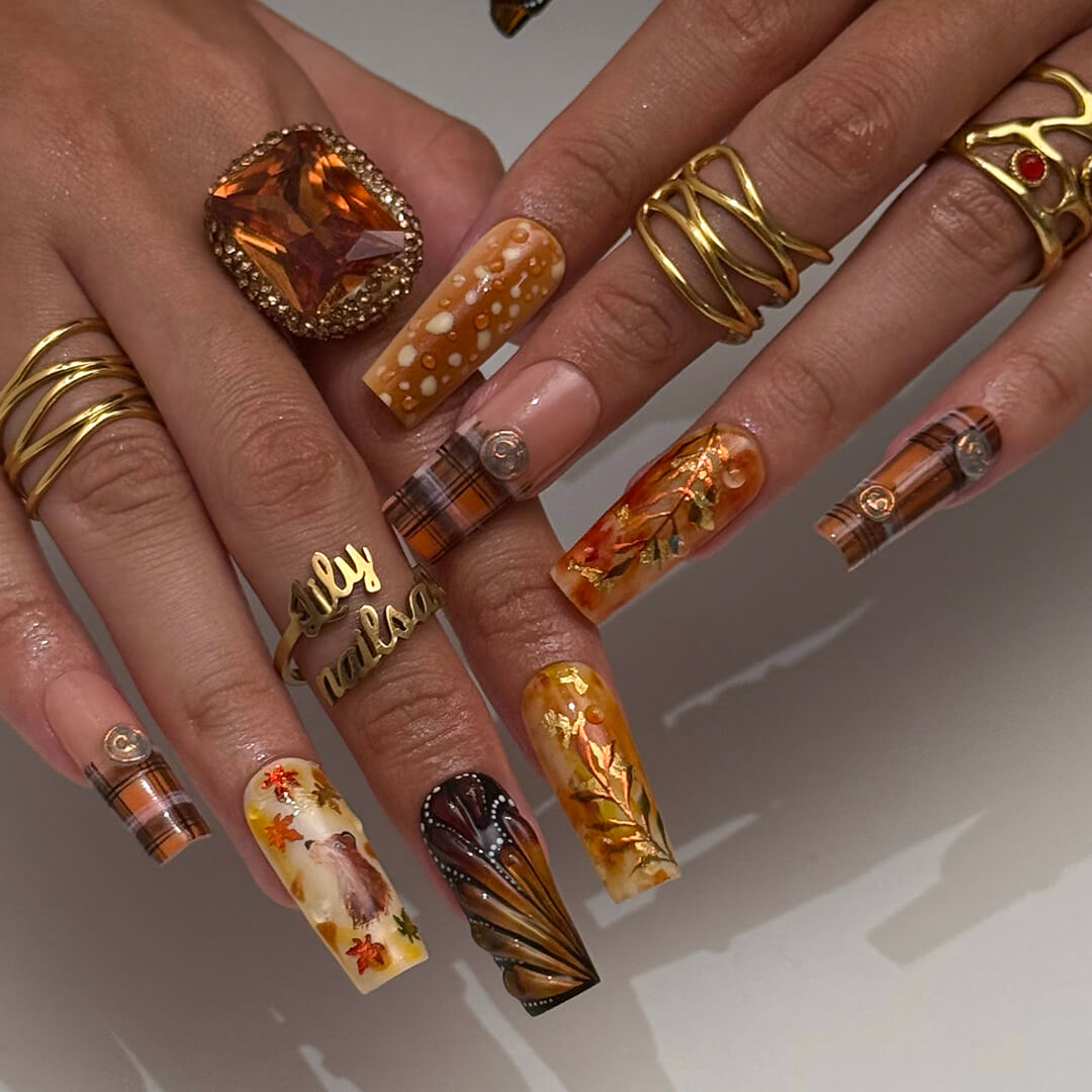 Luxury press-on nails with plaid patterns, golden foil leaves, tortoiseshell swirls, and warm caramel tones — handmade long almond nails — perfect for fall-inspired nail art, luxury everyday style, or elegant seasonal looks.