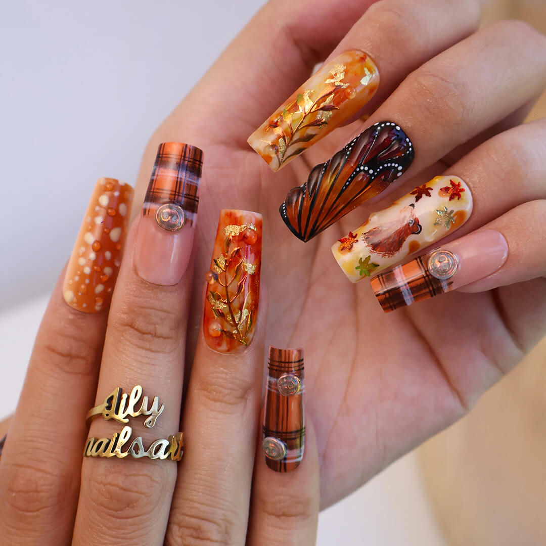 Luxury press-on nails with plaid patterns, golden foil leaves, tortoiseshell swirls, and warm caramel tones — handmade long almond nails — perfect for fall-inspired nail art, luxury everyday style, or elegant seasonal looks.