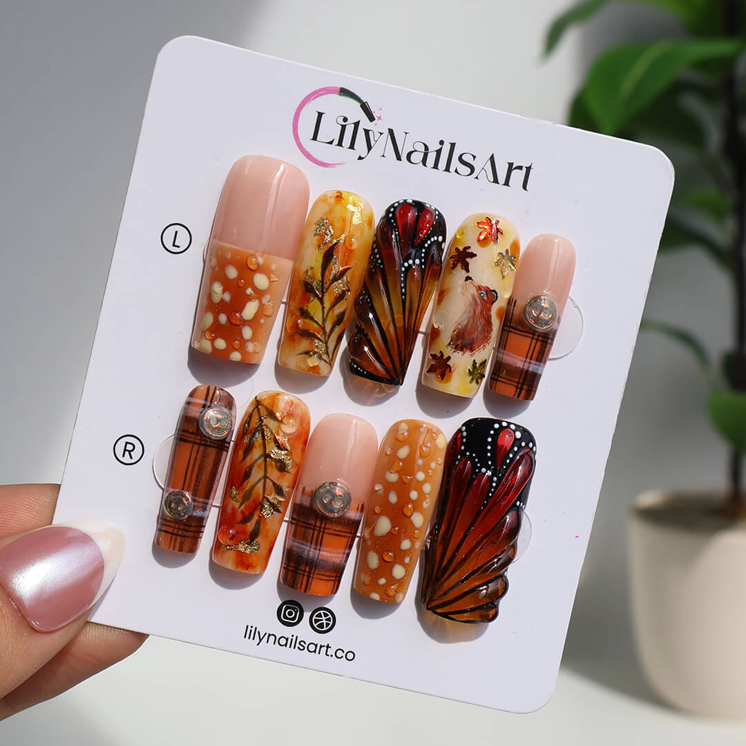 Luxury press-on nails with plaid patterns, golden foil leaves, tortoiseshell swirls, and warm caramel tones — handmade long almond nails — perfect for fall-inspired nail art, luxury everyday style, or elegant seasonal looks.