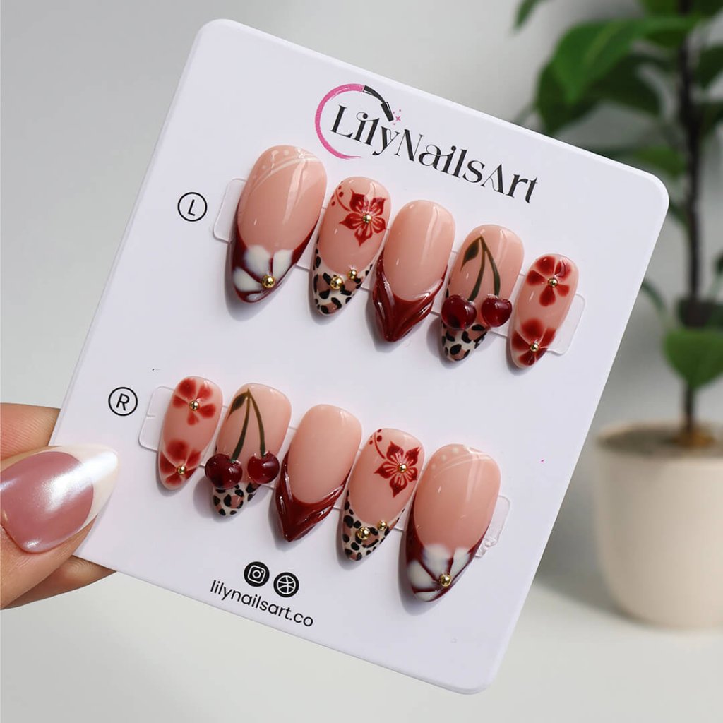 Cherry red press-on nails with hand-painted florals, subtle leopard accents, and glossy crimson tips — luxury handmade medium almond nails — perfect for elegant fall everyday looks, romantic evenings