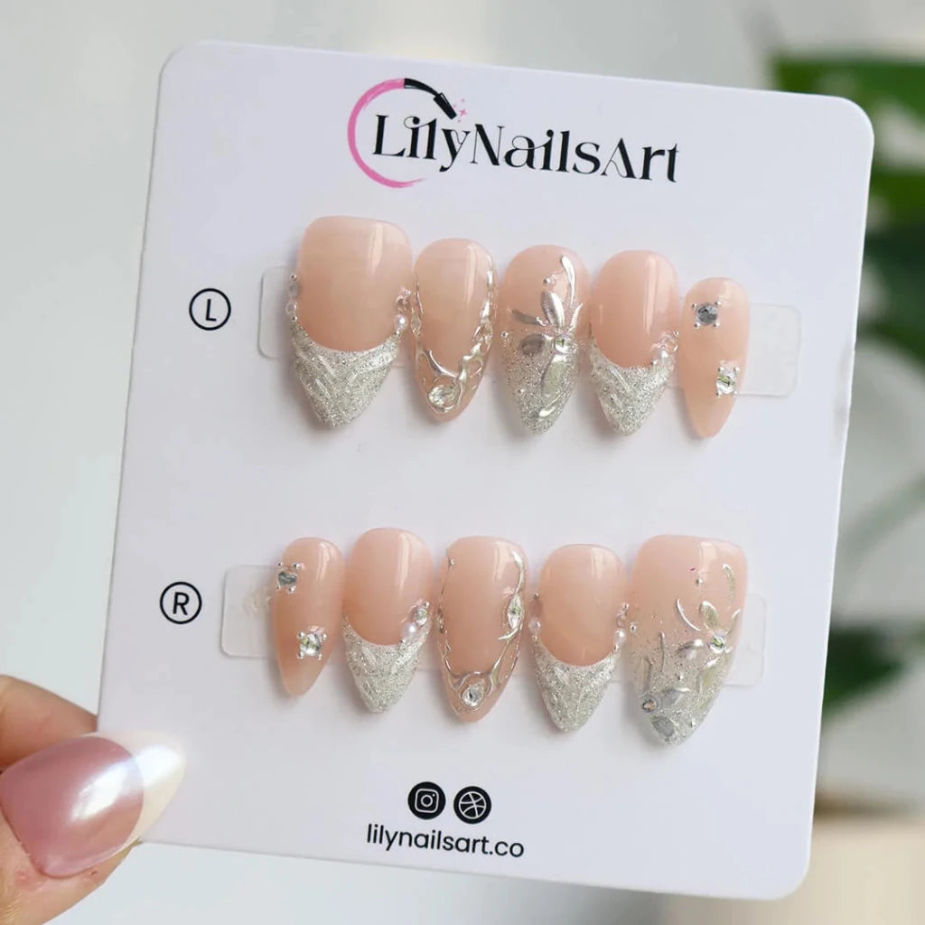 3D silver chrome press on nails with glitter V-tips and sculpted leaf accents, embellished with crystals and silver beads on a nude base — custom press on nails, luxury handmade nail art, fake nails, false nails, pressons — perfect for prom, winter formal, and silver-themed events