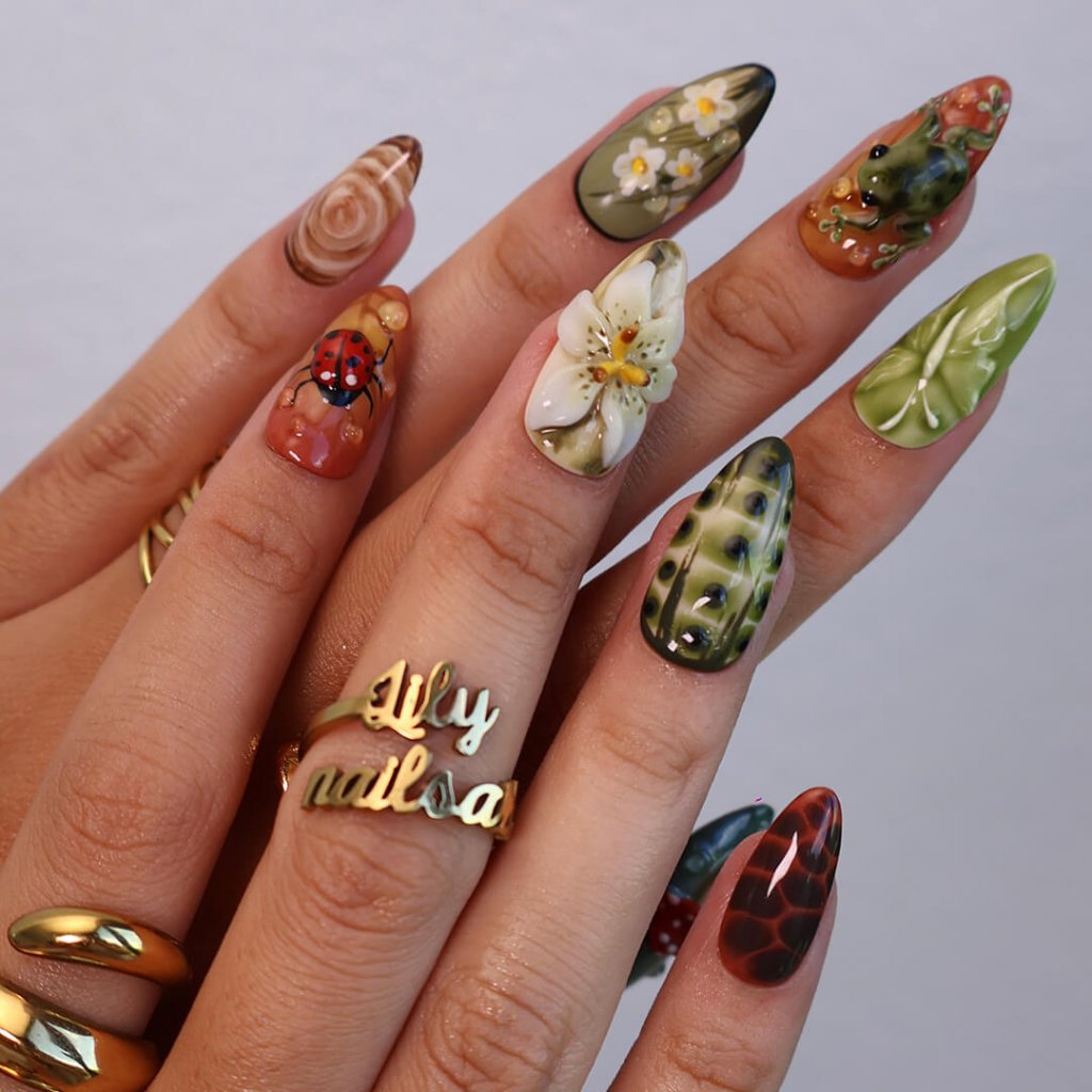 3D enchanted forest press-on nails with sculpted mushrooms, frogs, ladybugs, flowers, and woodland textures in earthy greens, browns, and reds — handmade medium almond nails — perfect for fairytale nail art, mystical styles, or fall luxury looks.