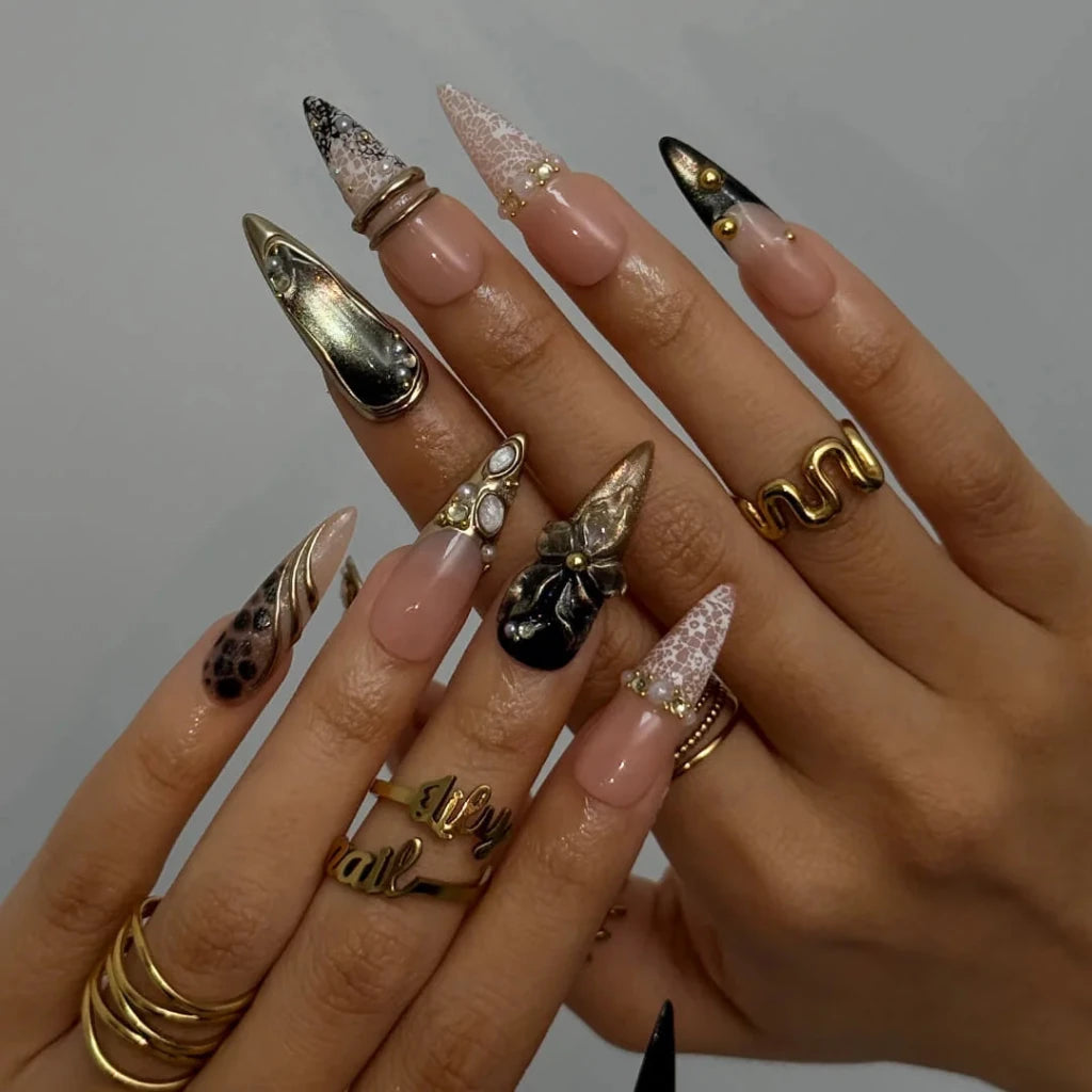 Noir Opulence - black and gold chrome press on nails by LilyNailsArt featuring 3D gold floral bows, lace overlays, leopard print accent, pearls, and crystal embellishments