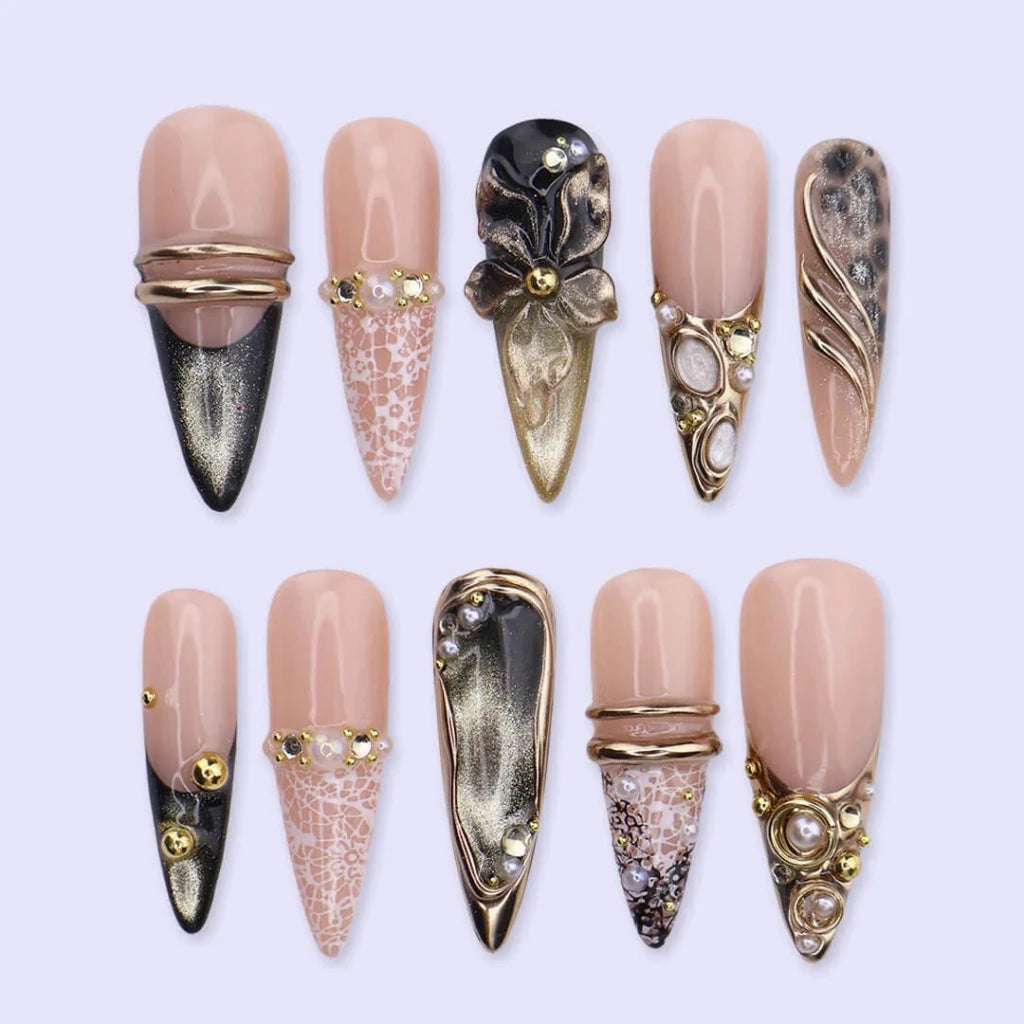 Noir Opulence - black and gold chrome press on nails by LilyNailsArt featuring 3D gold floral bows, lace overlays, leopard print accent, pearls, and crystal embellishments