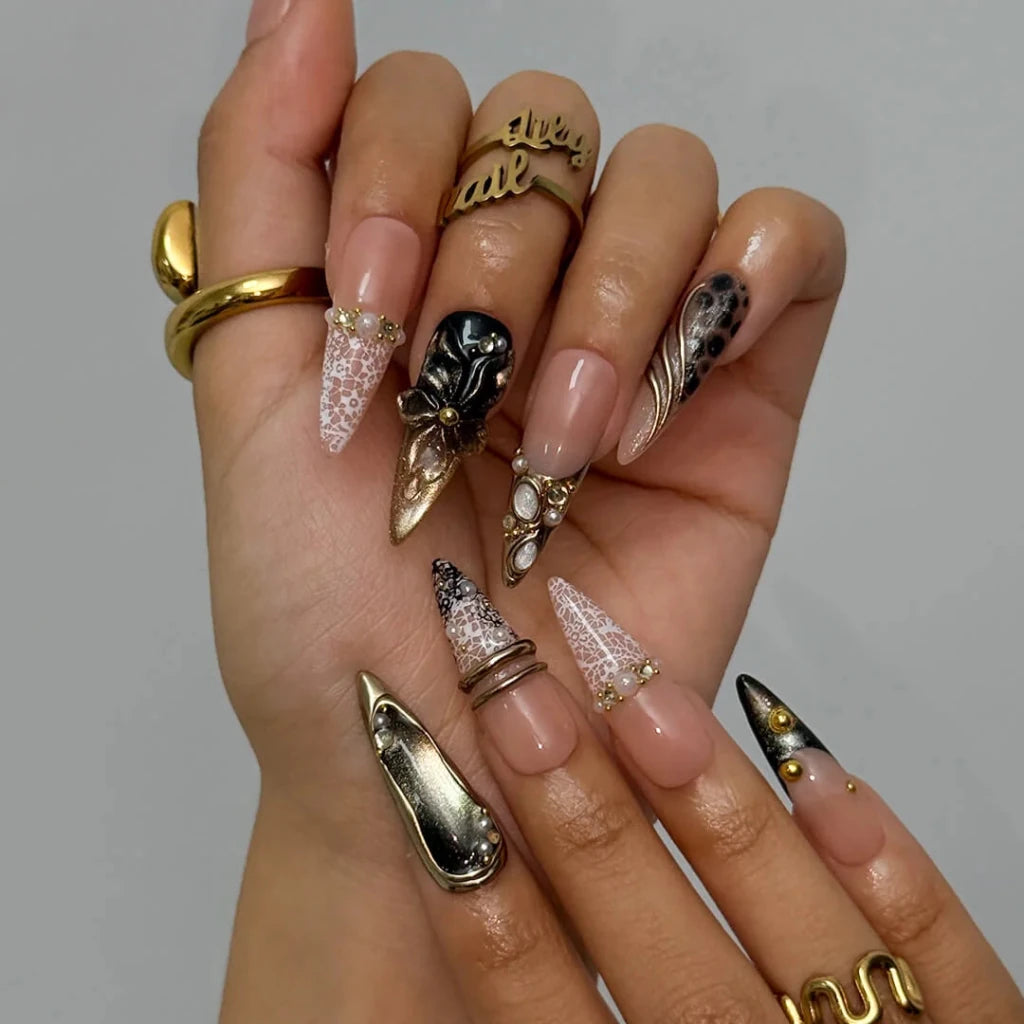 Noir Opulence - black and gold chrome press on nails by LilyNailsArt featuring 3D gold floral bows, lace overlays, leopard print accent, pearls, and crystal embellishments