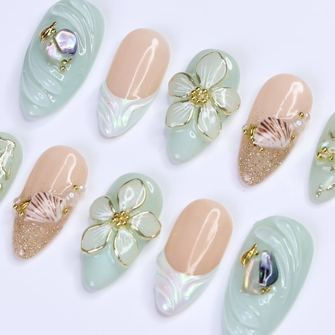 3D seafoam press-on nails with pearl flower accents, gold seashells, and iridescent wave textures — handmade luxury nail art, reusable and custom-sized false nails in a soft pastel green and nude colorway — perfect for beach weddings, summer travel, or romantic coastal looks.