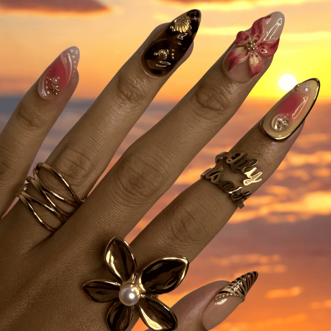 3D tropical press on nails with sculpted florals, tribal sun emblems, and gold details in coral, tan, and black tones — handmade nail art, reusable false nails, medium almond shape — perfect for beach vacations, holiday or summer festivals