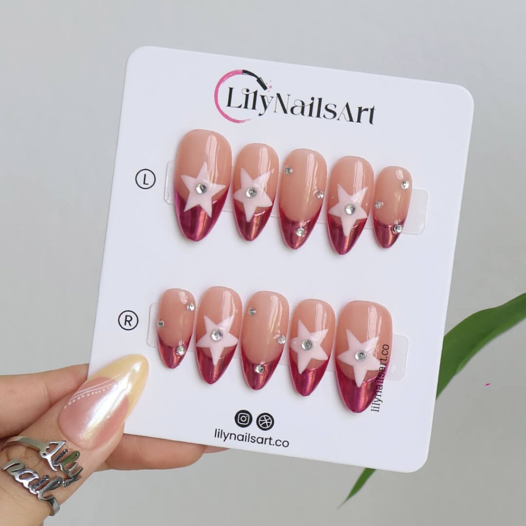 Chrome pink press-on nails with nude bases, 3D pastel star, and rhinestone crystals — handmade medium almond nails with futuristic cosmic design — perfect for parties, festivals, or bold statement looks.