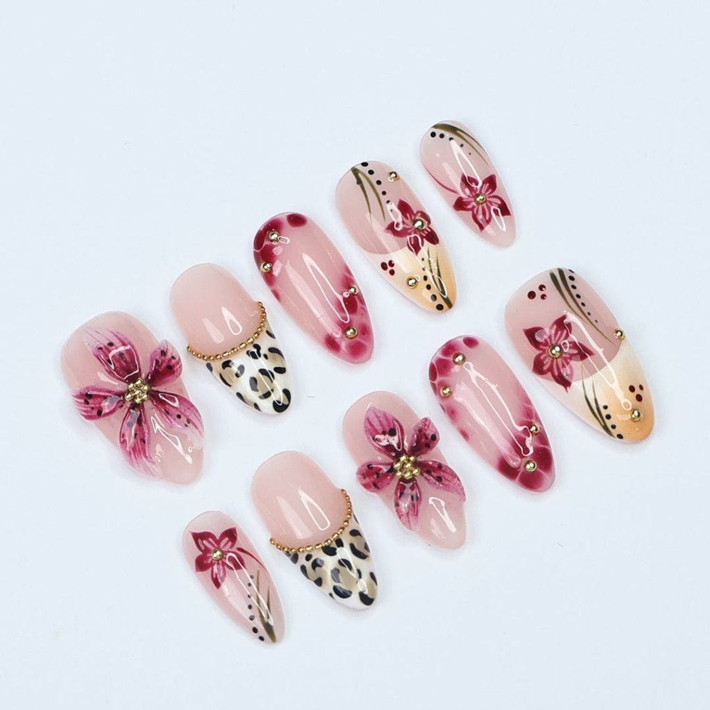 Handmade spring press-on nails featuring delicate 3D sakura flowers, leopard print French tips, and gold accents. Designed in a soft pink color palette with a glossy finish, perfect for floral nail lovers, holiday nails, vacation-ready nails, and birthday nail sets.
