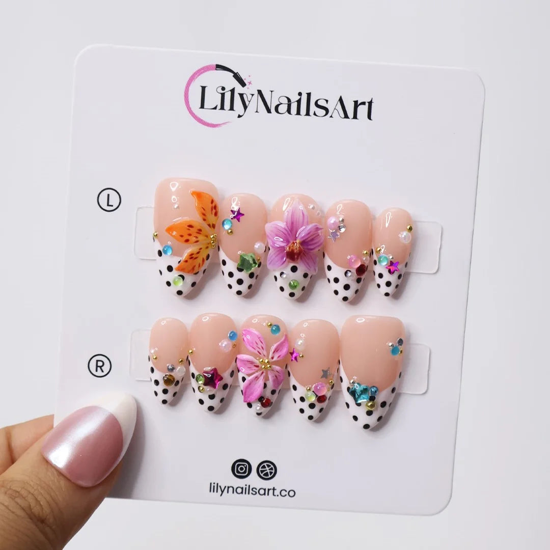 Handmade summer press-on nails with black polka dot French tips, tiger lily, orchid and rainbow gemstone confetti embellishments by Lily Nails Art
