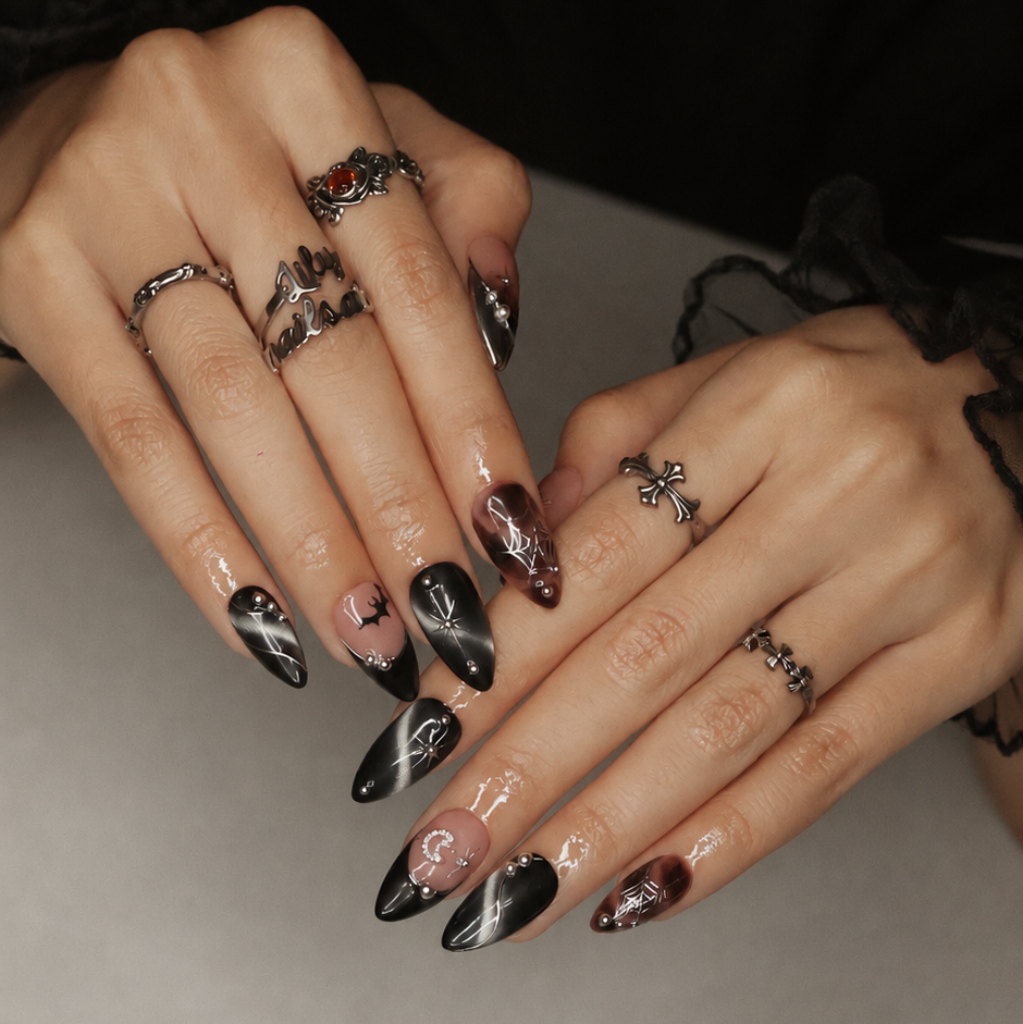Batwing handmade gothic Halloween press-on nails — medium almond set in nude, black cat-eye and smoky brown with silver chrome tips, bats, rhinestone crescent moon and silver spiderwebs.