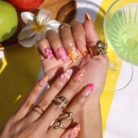 Handmade summer press-on nails with coral pink blooms, 3D floral centerpiece, leopard dots and gold spiral details by Lily Nails Art