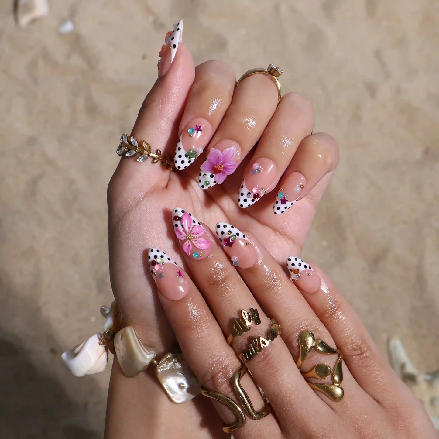 Handmade summer press-on nails with black polka dot French tips, tiger lily, orchid and rainbow gemstone confetti embellishments by Lily Nails Art